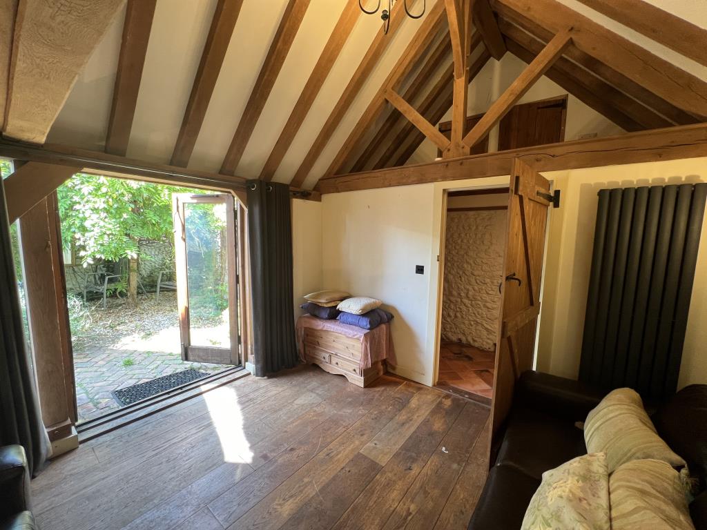 Lot: 138 - TWO-BEDROOM THATCHED COTTAGE FOR OCCUPATION OR INVESTMENT - Modern extension with exposed wooden beams